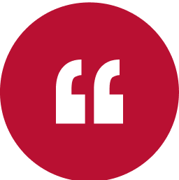 White quotation marks on a red circular background.