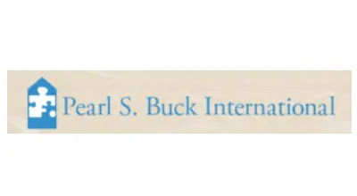 Logo of Pearl S. Buck International featuring a blue house icon with a puzzle piece and text on a light background.